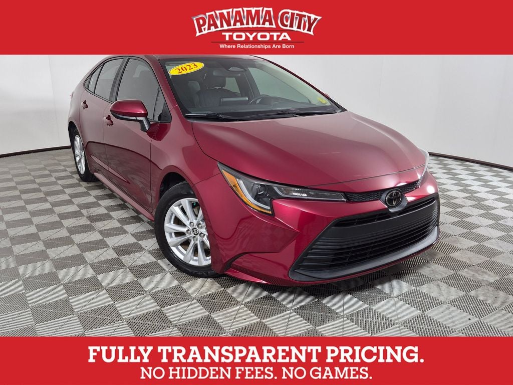 2023 Toyota Corolla LE in Ruby Flare Pearl — front three-quarter view